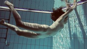 Gorgeous Sima swims naked in a pool exposing her beauty