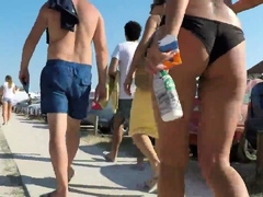 Beach voyeur follows sexy slender babe in tight bikini