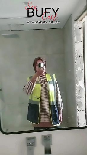 Turkish girl with headscarf who turns on the camera and puts on a show at the construction site