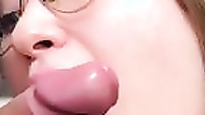 Nerdy teen girl with glasses is learning how to give a proper blowjob