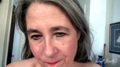 Mature chubby granny explores her hairy pussy during a solo yoga session on the purple mat