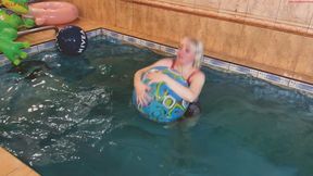 Alla plays with two beach balls in the pool