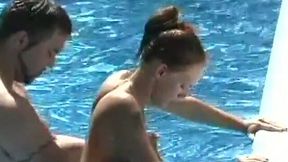 Nice bikini brunette gets poked doggy in the swimming pool