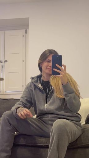 Woman in grey sweatpants taking selfie